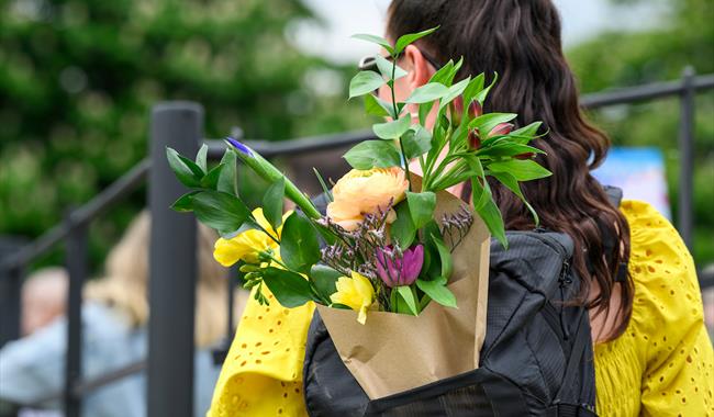 Woman with flowers in her backpack at the BBC Gardeners' World Spring Fair