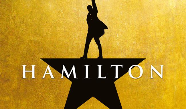 Black star on a gold background. Top point is a man pointing up.