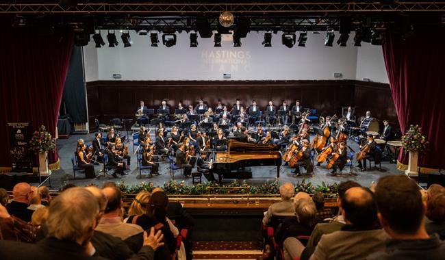 orchestra on stage with conductor