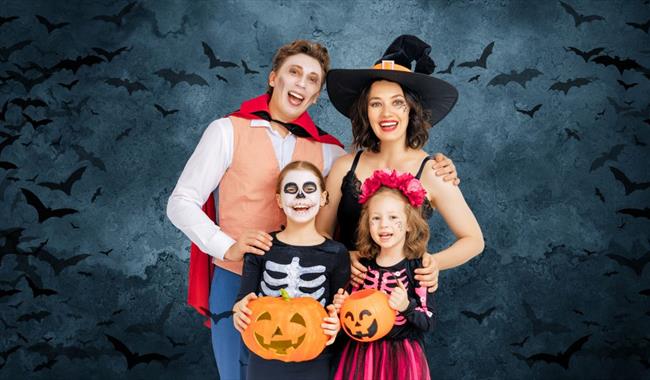 Family dressed in costume for Halloween.