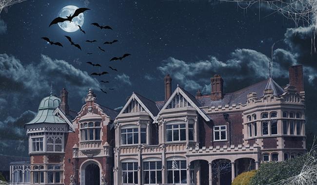 A picture of Bletchley Park in a spooky setting at night, with bats and cobwebs