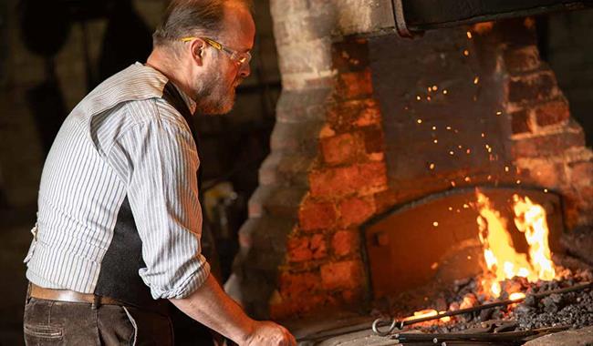 Blacksmith working in a Victorian forge
