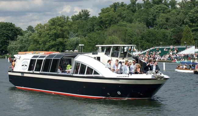 boat on the river with people watching Henley Regatta