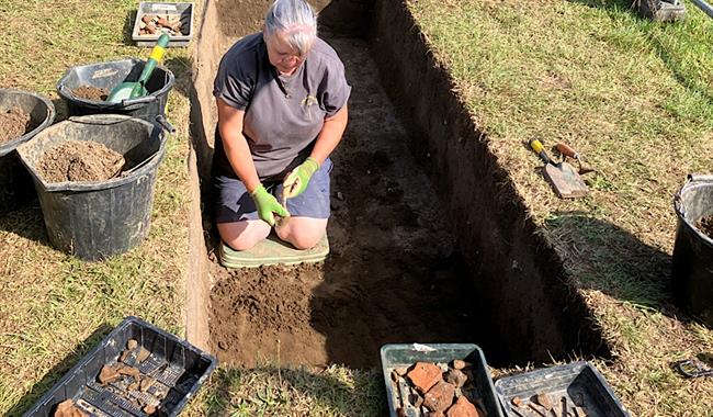 Archaeologist in test pit in Liss, East Hampshire