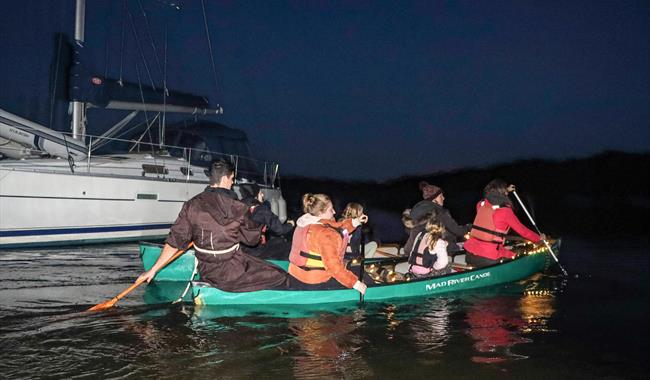 A family paddling along the Beaulieu River on New Forest Activities Spooky Halloween River Tour