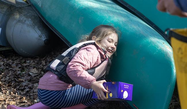 A young girl searching for easter eggs on New Forest Activities Canoe Easter Egg Hunt