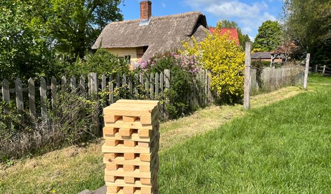 jenga set infront of old yellow cottage