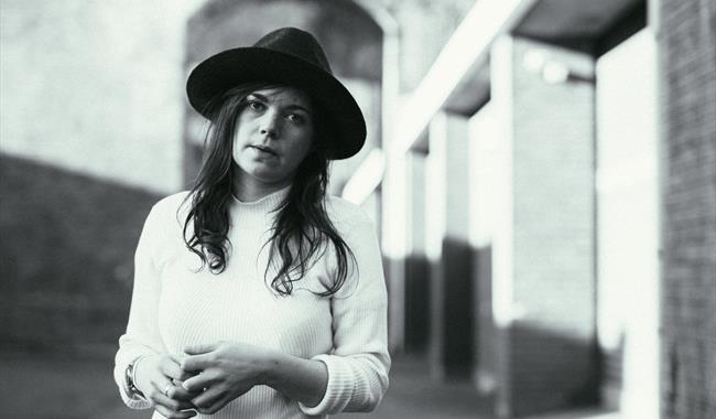 Image: Black and white image of Jessie Reid standing outside