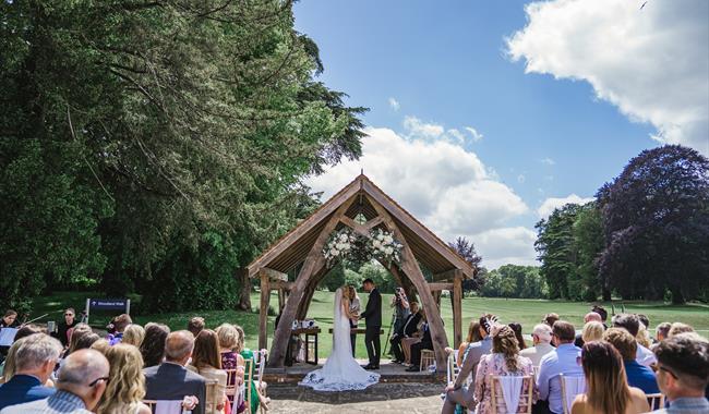 Outdoor wedding ceremony at Oakley Hall Hotel
