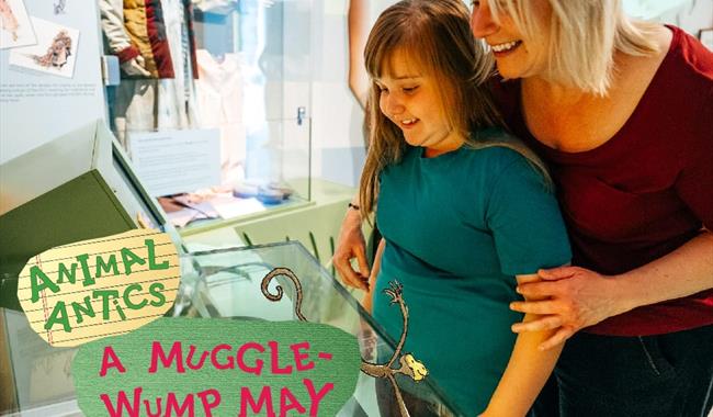A daughter and mom looking into an exhibition case with big smiles on their faces