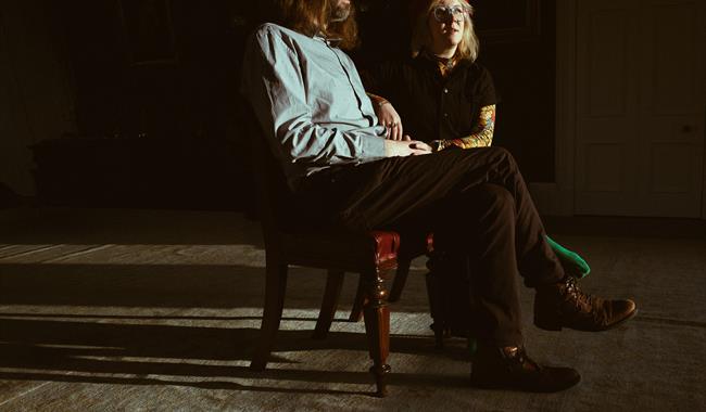 Image: M G boulter and Samantha Whates sat down on chairs with a shadow of the chairs