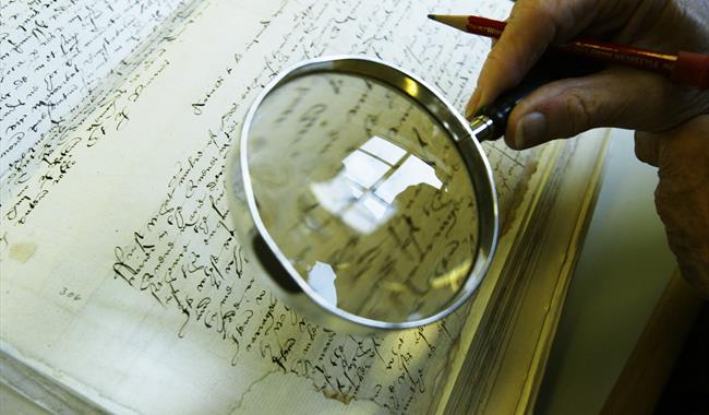 a magnify glass looking at a document