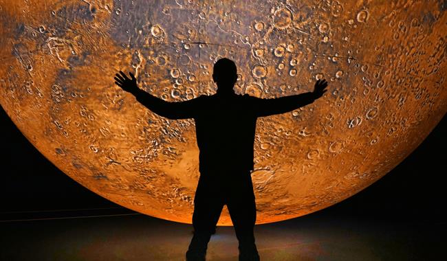A person stands under mars