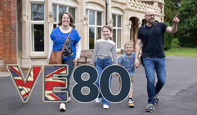 A family of a mum, dad, daughter and son outside Bletchley Park Mansion