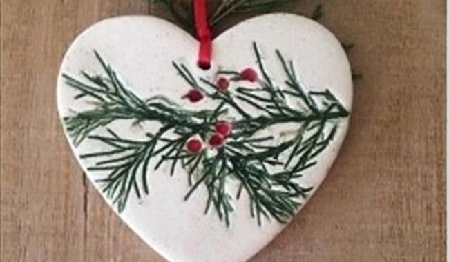 Heart shaped ceramic with pressed pine and berries shapes