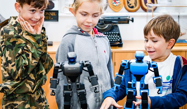 Visitors play with robots in the Victory Gallery