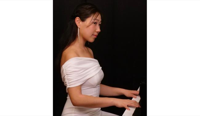 Nurry Lee in a White Dress at the Piano