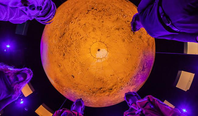 People stand under Mars