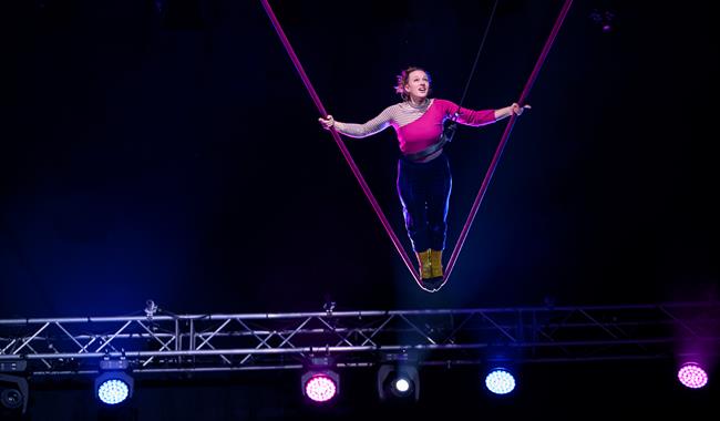 Trapeze artist performing trick