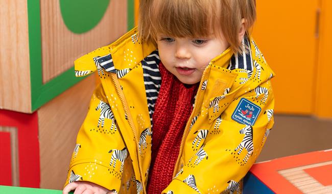 Small girl playing with toys