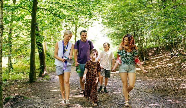 Family walking in leafy woods