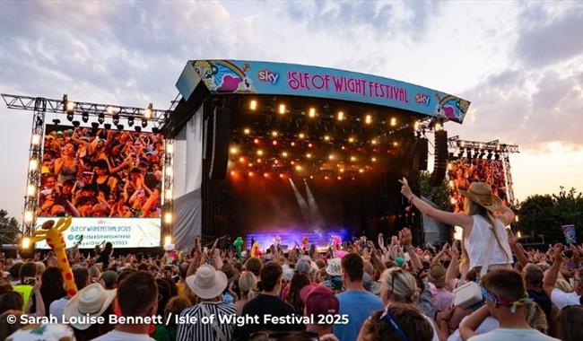 Crowds watching a band on the main stage at the Isle of Wight Festival, music event, what's on