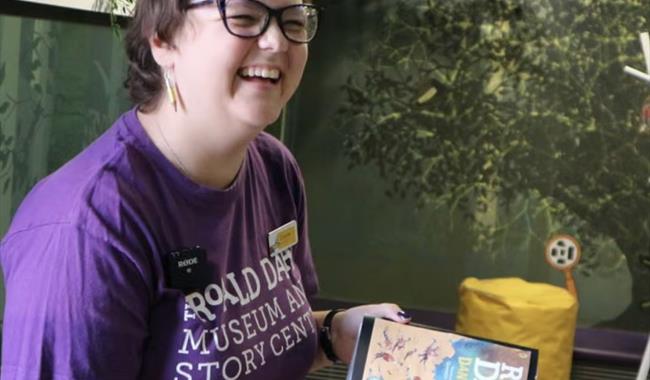 Woman holding a book and smiling