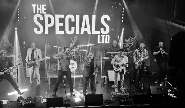 Image: Band on stage in black and white photo