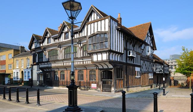 Picture of the front of Tudor House with blue sky in the background