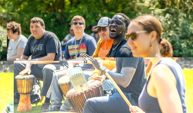 smiling people playing drums