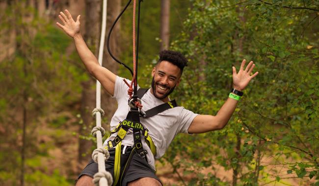 Man on zipline at Go Ape Crawley