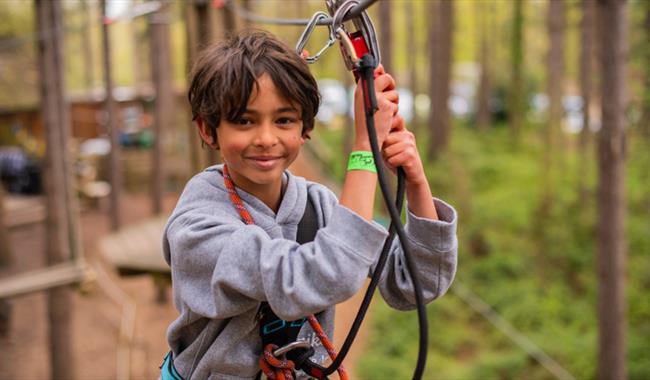 Child on clipped onto high ropes course at Go Ape Bedgebury in Kent
