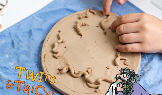 A child's hands playing with clay at Roald Dahl Museum and Story Centre, Buckinghamshire
