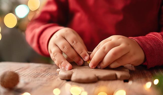 A child making a shape out of clay