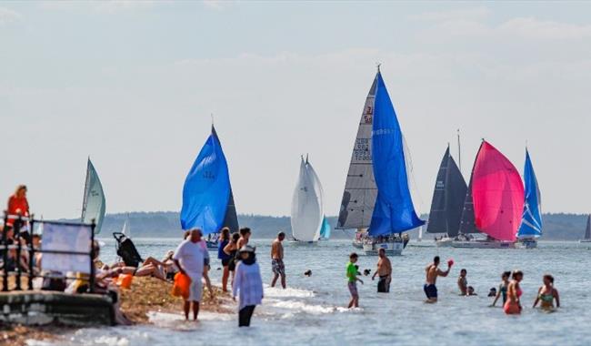 People swimming in the sea watching the boats sailing, Cowes Week, event, what's on