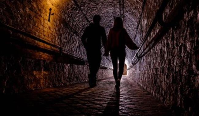 Couple taking tour of Dover Castle tunnels