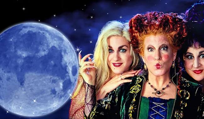 Hocus Pocus movie poster. A dark, starry background with a full moon on the left and 3 witches on the right.