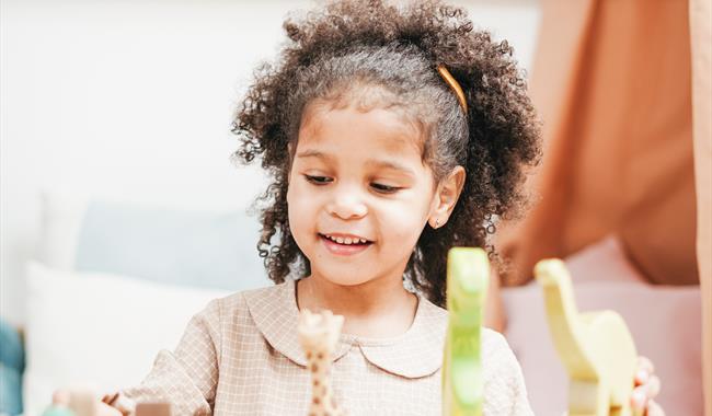 Image of young child playing with wooden toys