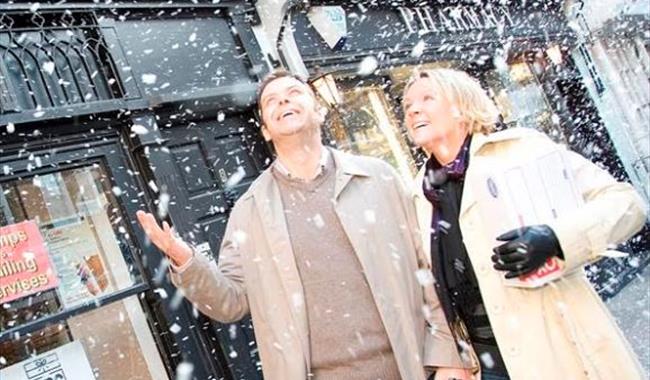 Couple in marlow high street with 'snow effect'.