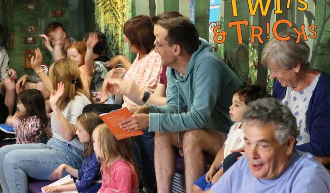 Children listening and watching storytelling at Roald Dahl Museum and Story Centre, Buckinghamshire