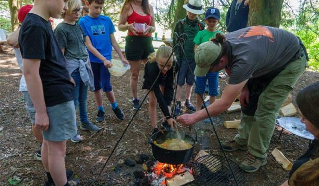 Children cooking around an open fire