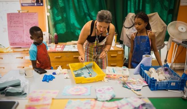 Children and an adult being creative with crafts