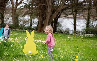 Children on the grass enjoying an Easter trail
