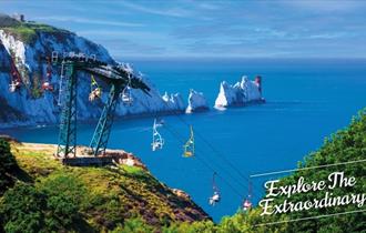 View of the Needles in the background with people on the chairlift, The Needles Landmark Attraction, Isle of Wight, Things to Do