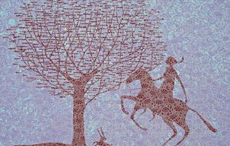 A figure on a horse, rearing above a rabbit.