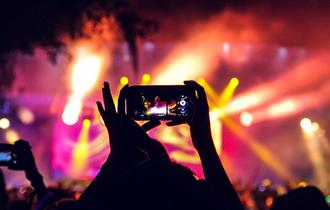 People at a concert taking pictures with phones