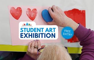 student stamping love hearts with the words 'student art exhibition'
