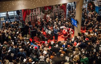 Howden Christmas Racing Weekend at Ascot | people carol singing with Ascot Brass Band