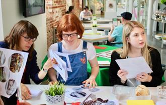Three people taking part in a craft activity at Aspex Portsmouth