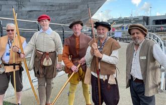 Archers gathered outside The Mary Rose in Tudor wear.